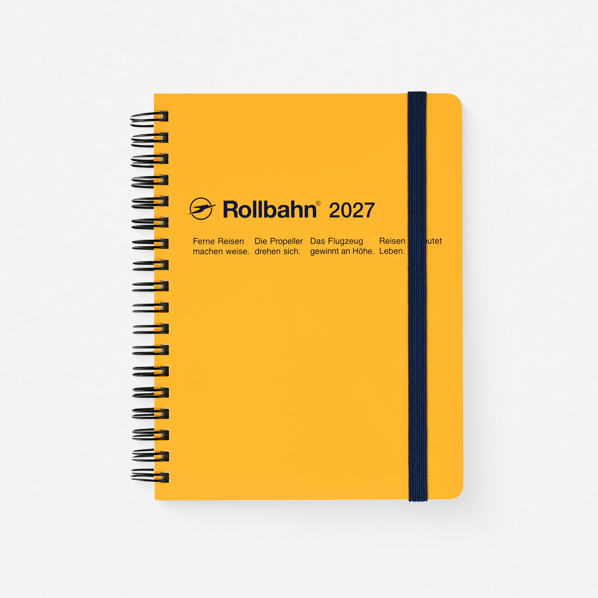 A yellow 2027 Rollbahn planner with indigo printing, black spiral binding and navy elastic band